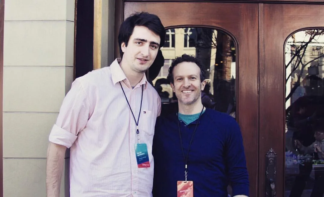 Me standing next to Jason Fried outside a venue in Redwood City, both of us wearing Startup Grind lanyards.