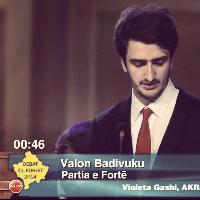 A still from KALLXO's Debat Zgjedhjet 2014 broadcast, showing me at the podium in a suit and red tie with the lower third reading "Valon Badivuku, Partia e Fortë".